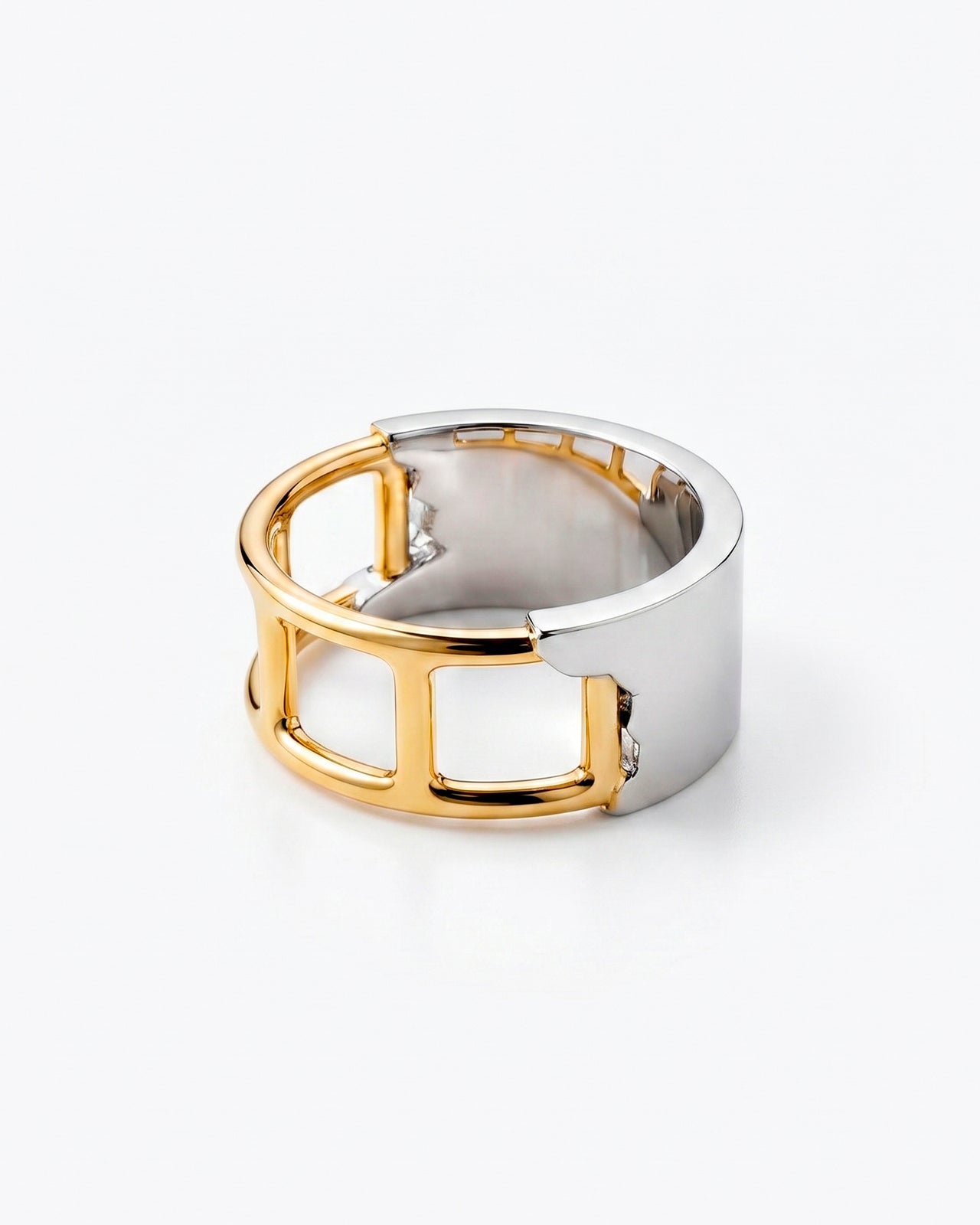 Wide ring with an open architectural cut-out structure in gold and silver