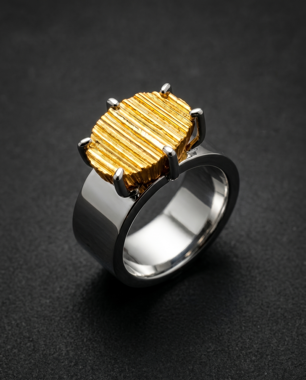 Chunky ring with a rough textured metal block in place of a gemstone