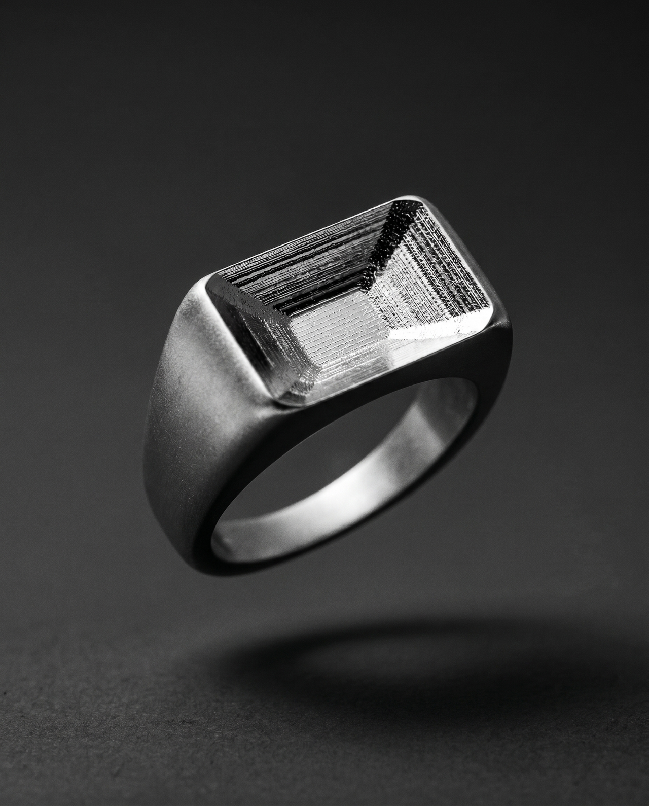 Chunky matte silver signet ring with a hollow faceted top