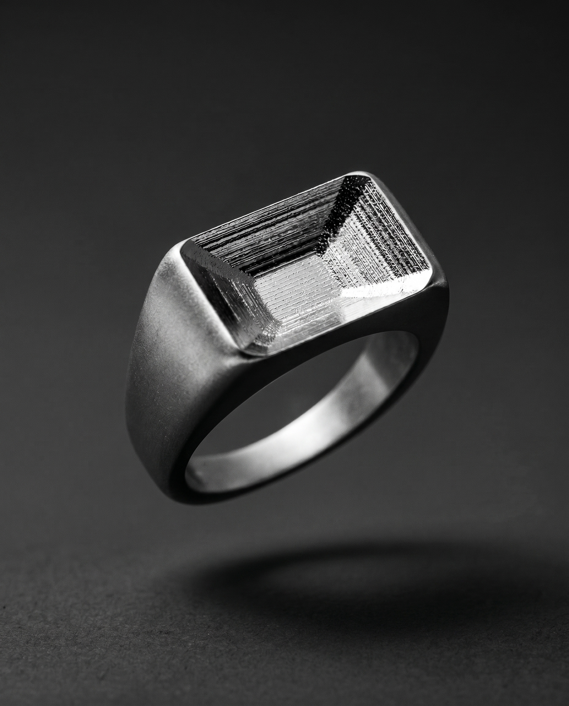 Chunky matte silver signet ring with a hollow faceted top