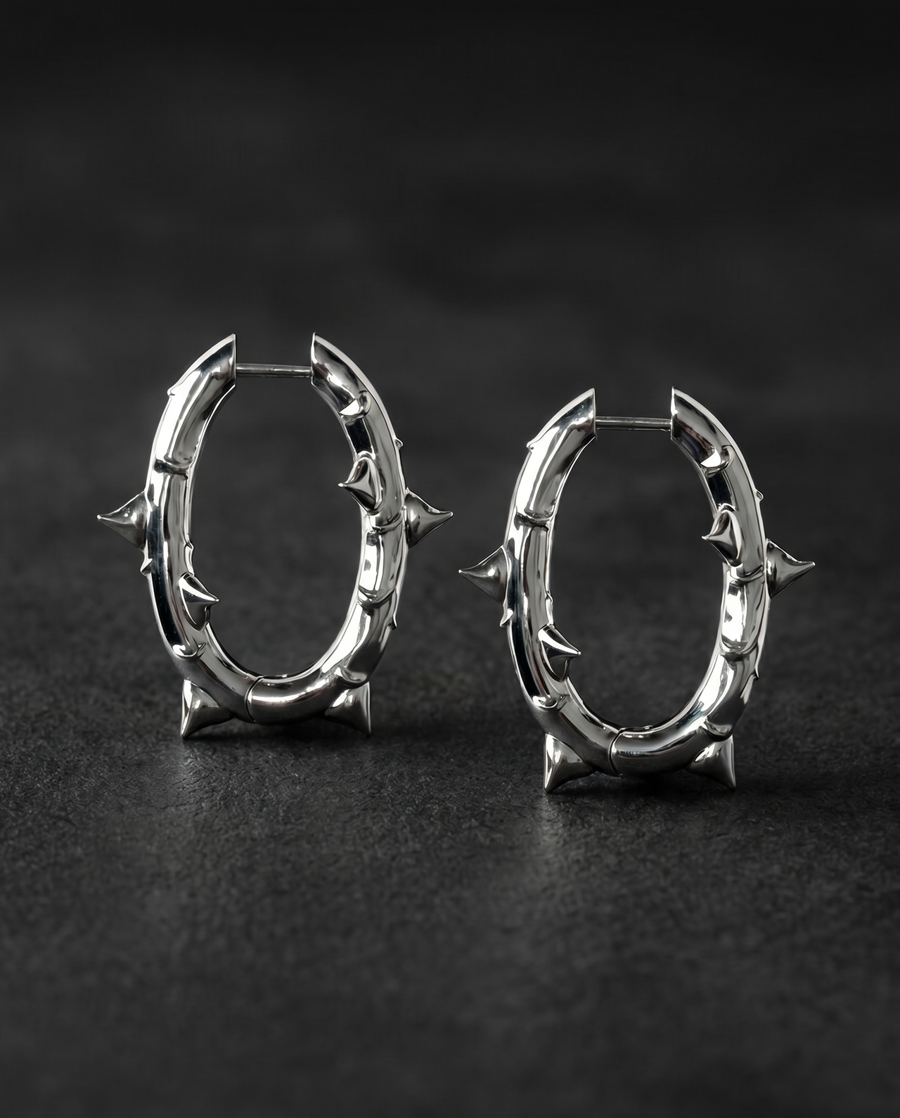 Pair of silver thorn-spiked oval hoop earrings