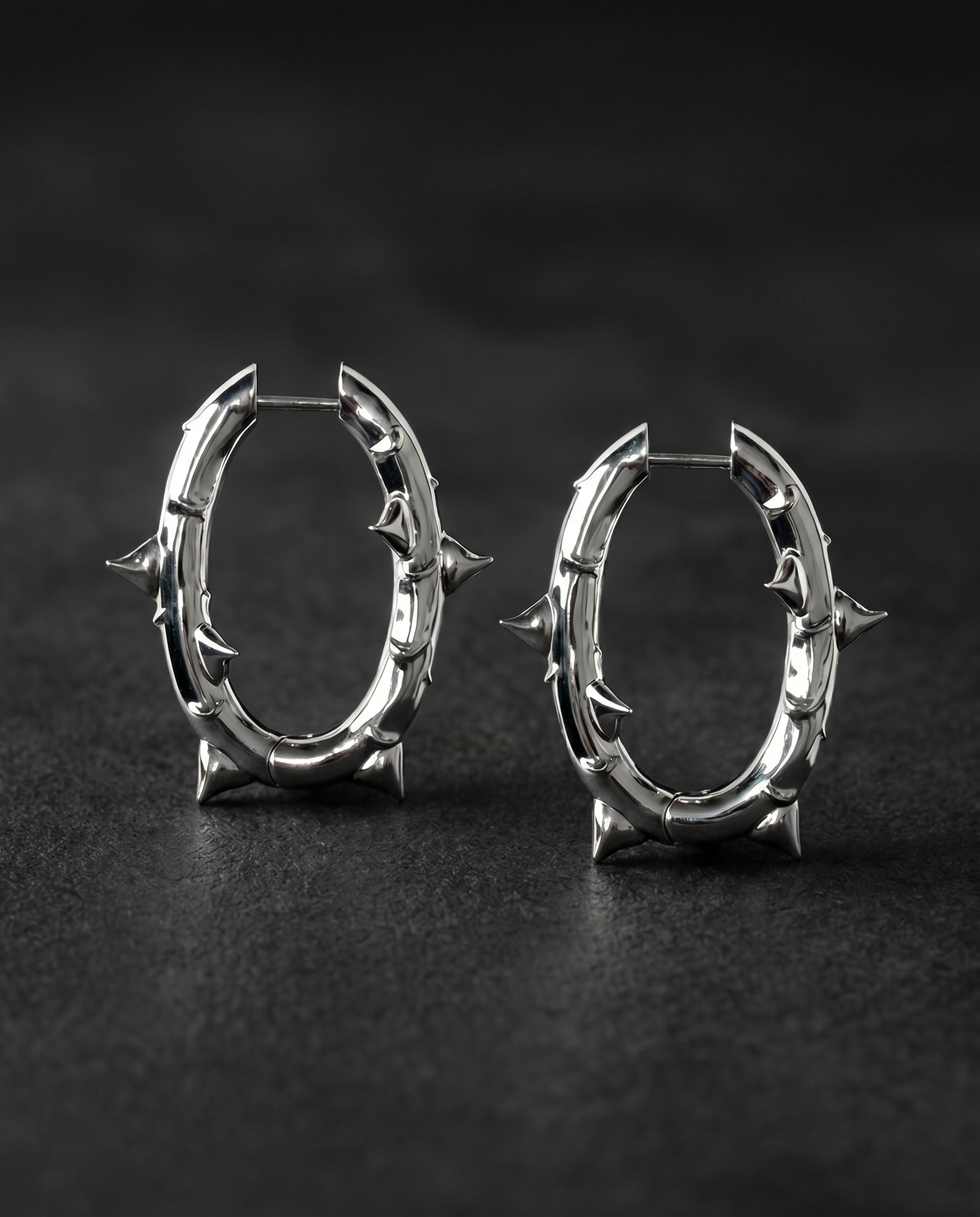 Pair of silver thorn-spiked oval hoop earrings
