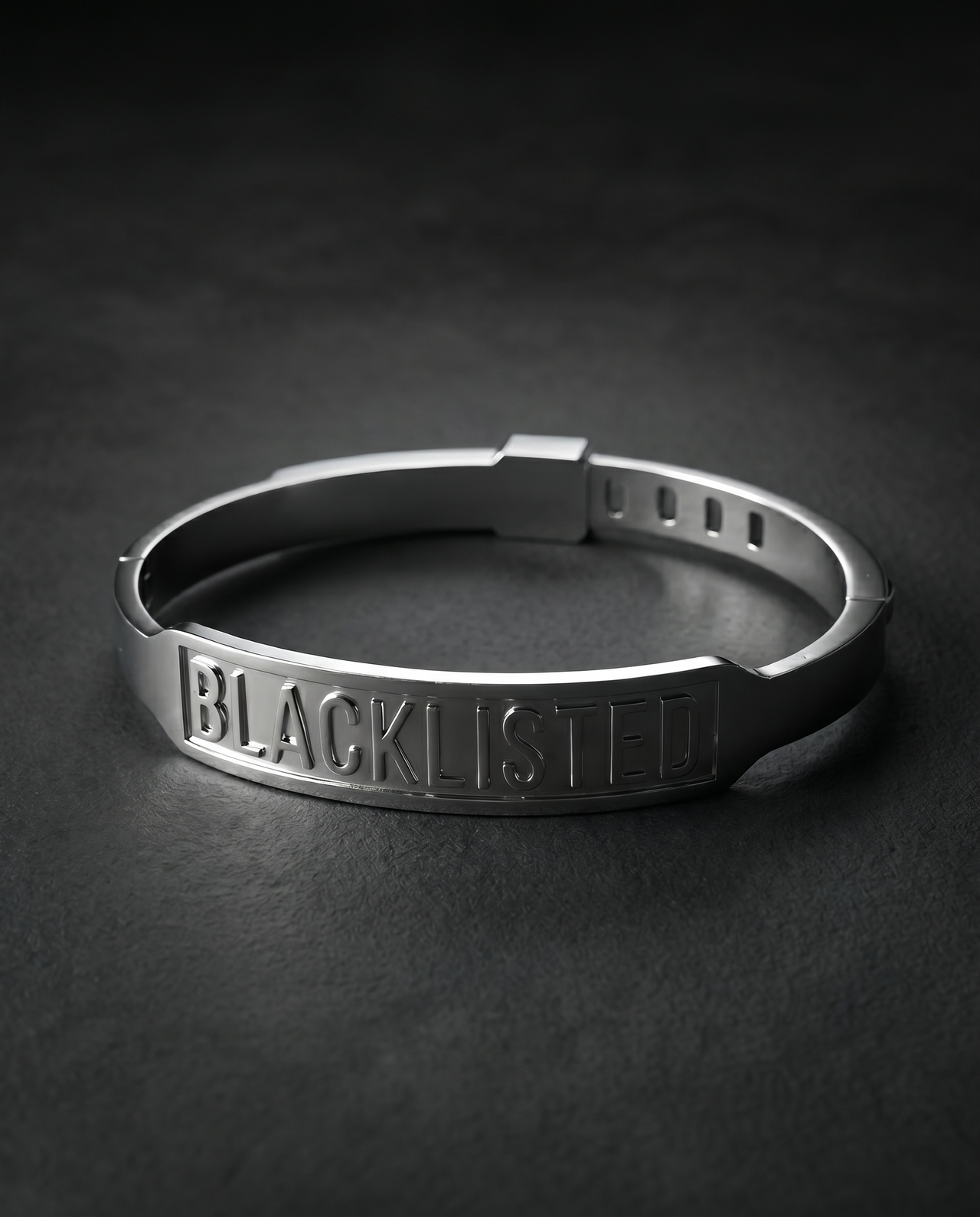 Silver cuff bracelet engraved with the word BLACKLISTED