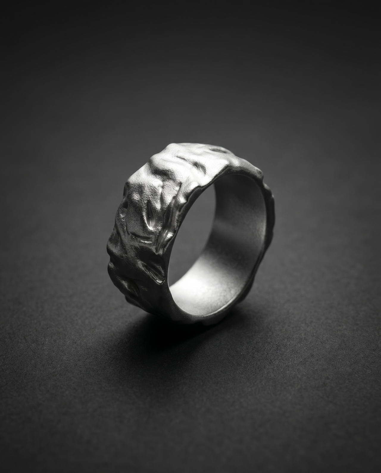 Wide textured band ring with a raw molten surface in gold and silver