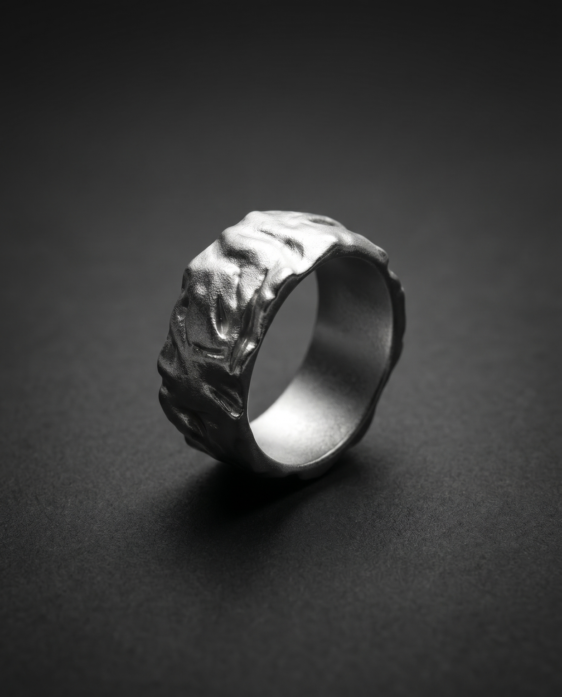Wide textured band ring with a raw molten surface in gold and silver