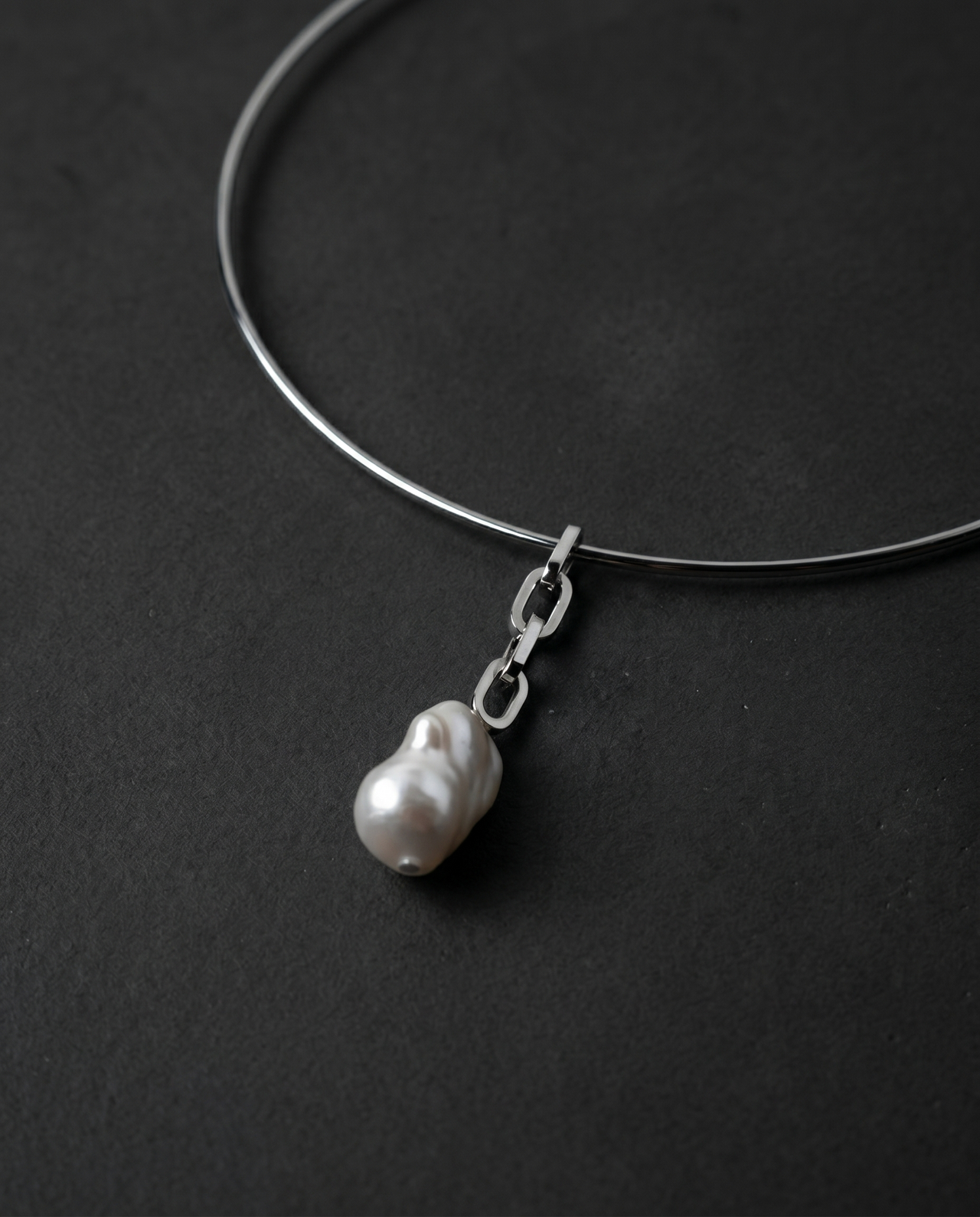 Single raw freshwater pearl on a thin metal choker
