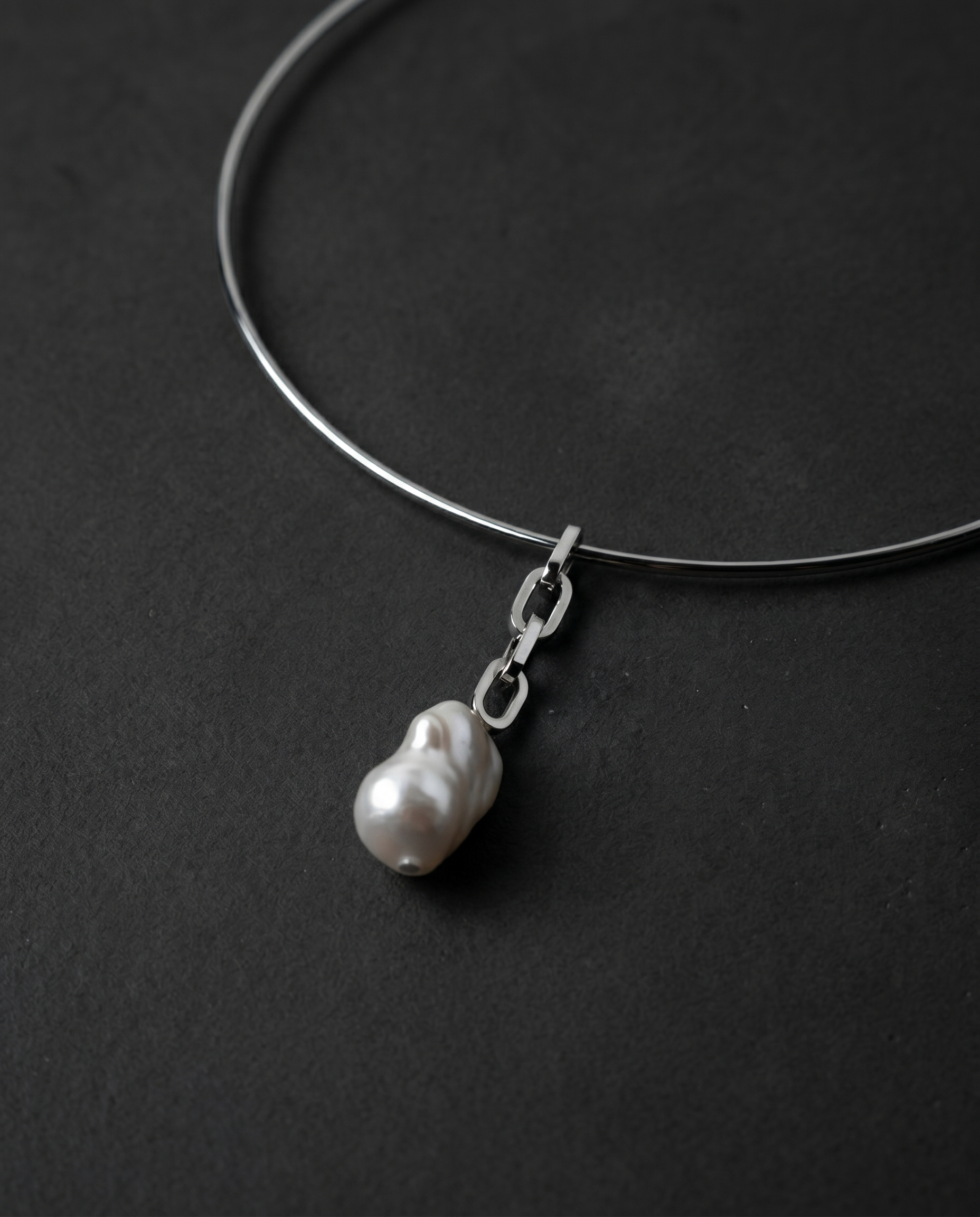 Single raw freshwater pearl on a thin metal choker