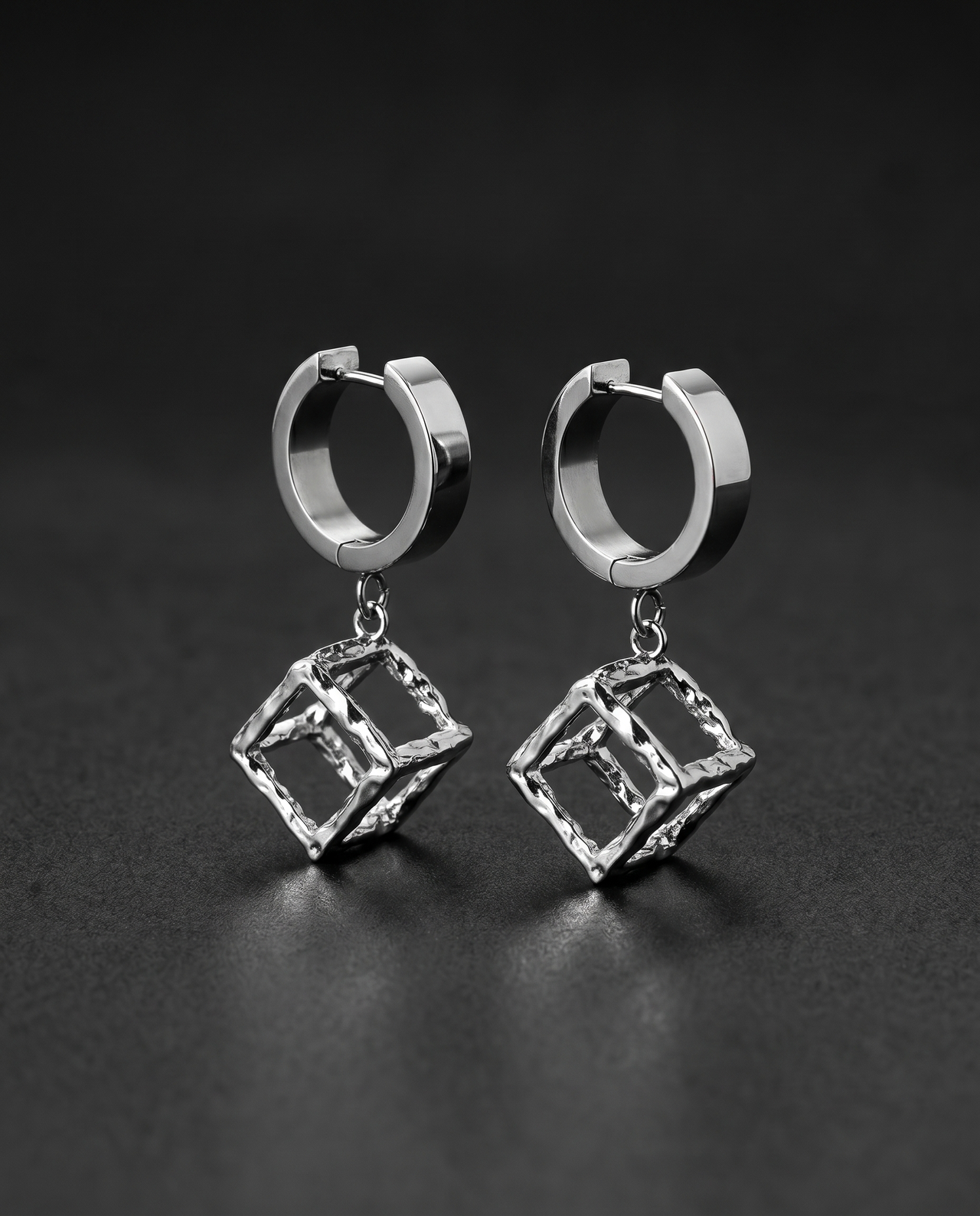 Silver hoop earrings with open sculptural metal cube drops