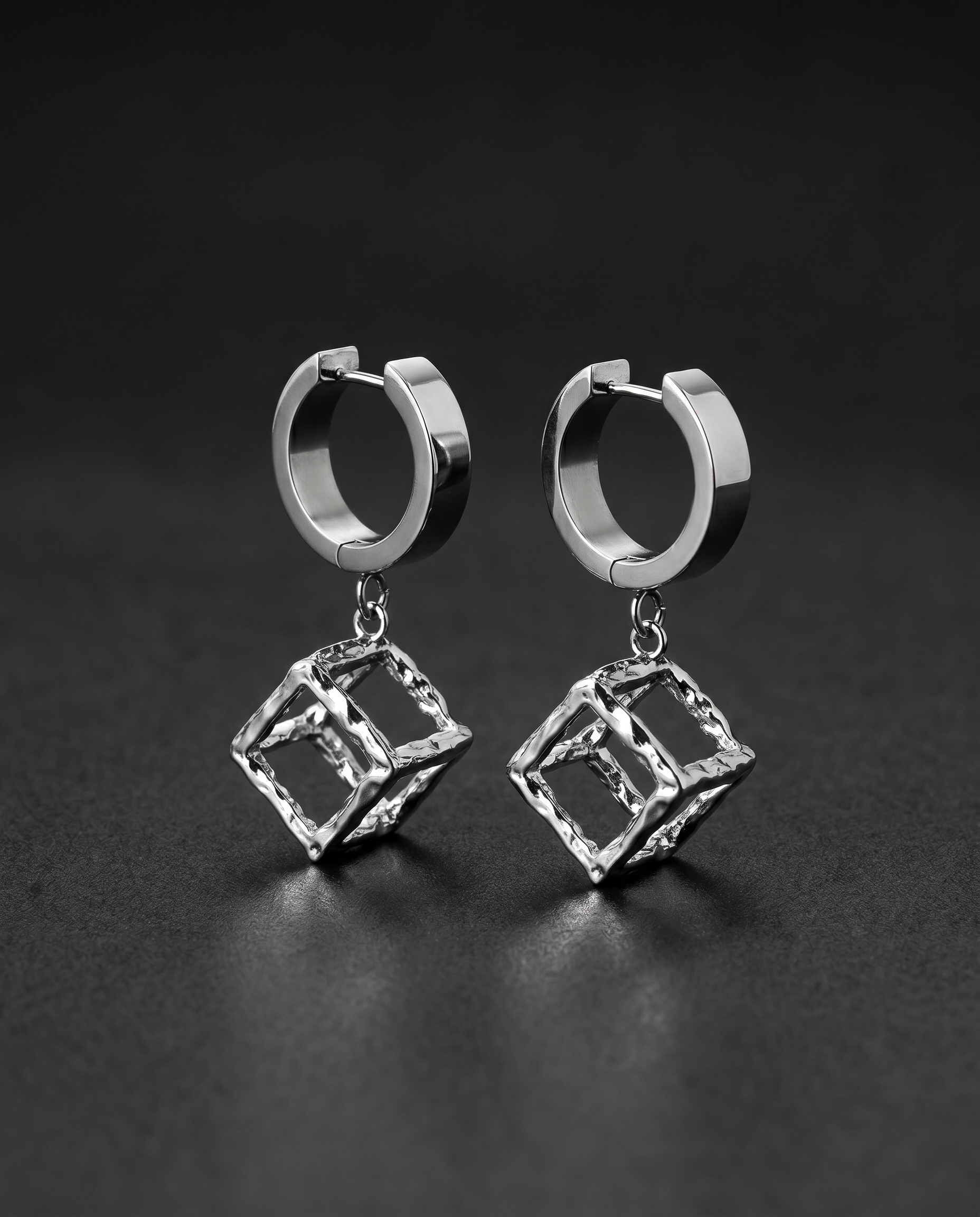Silver hoop earrings with open sculptural metal cube drops