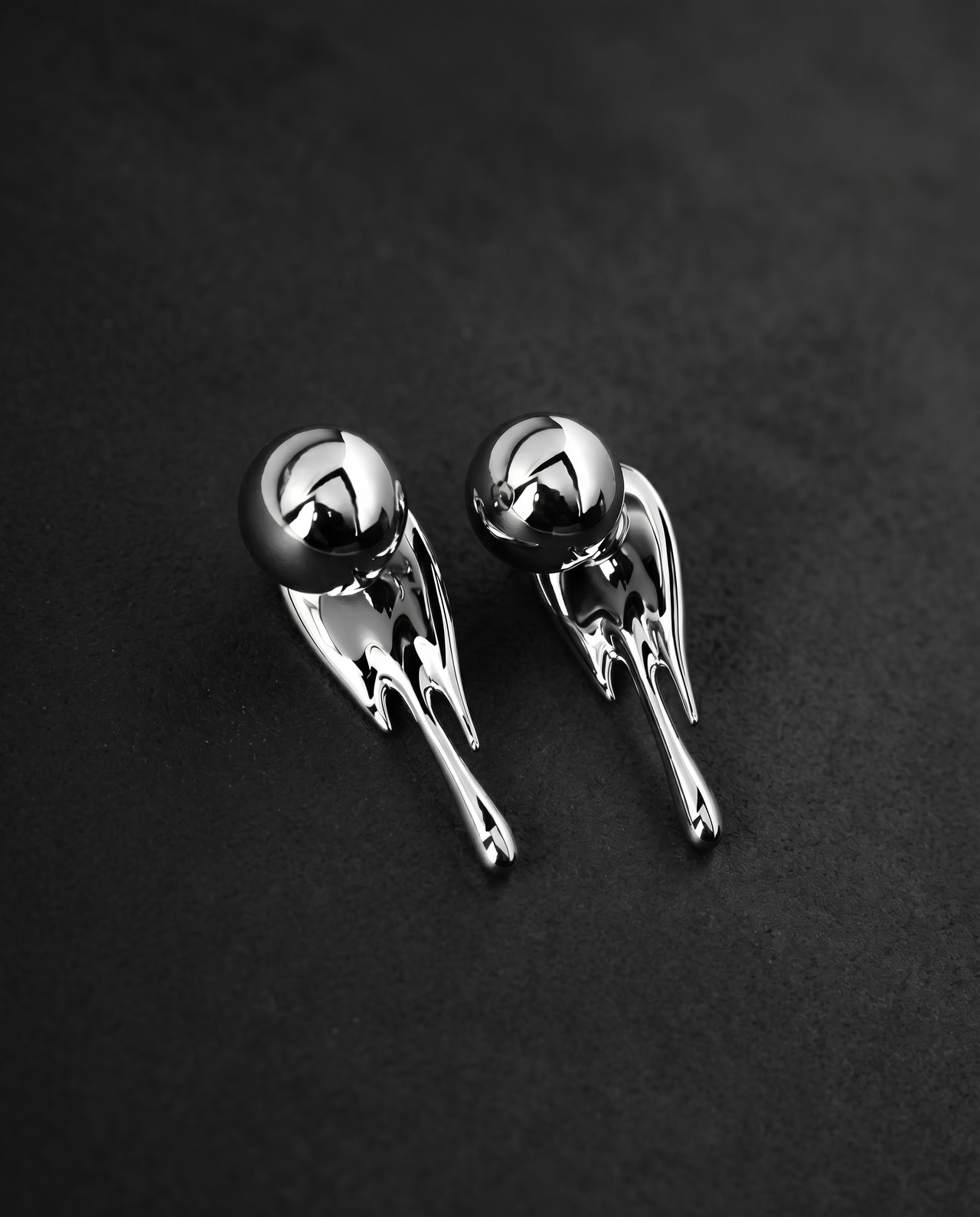 Pair of mirror-polished molten metal drop earrings in silver and gold